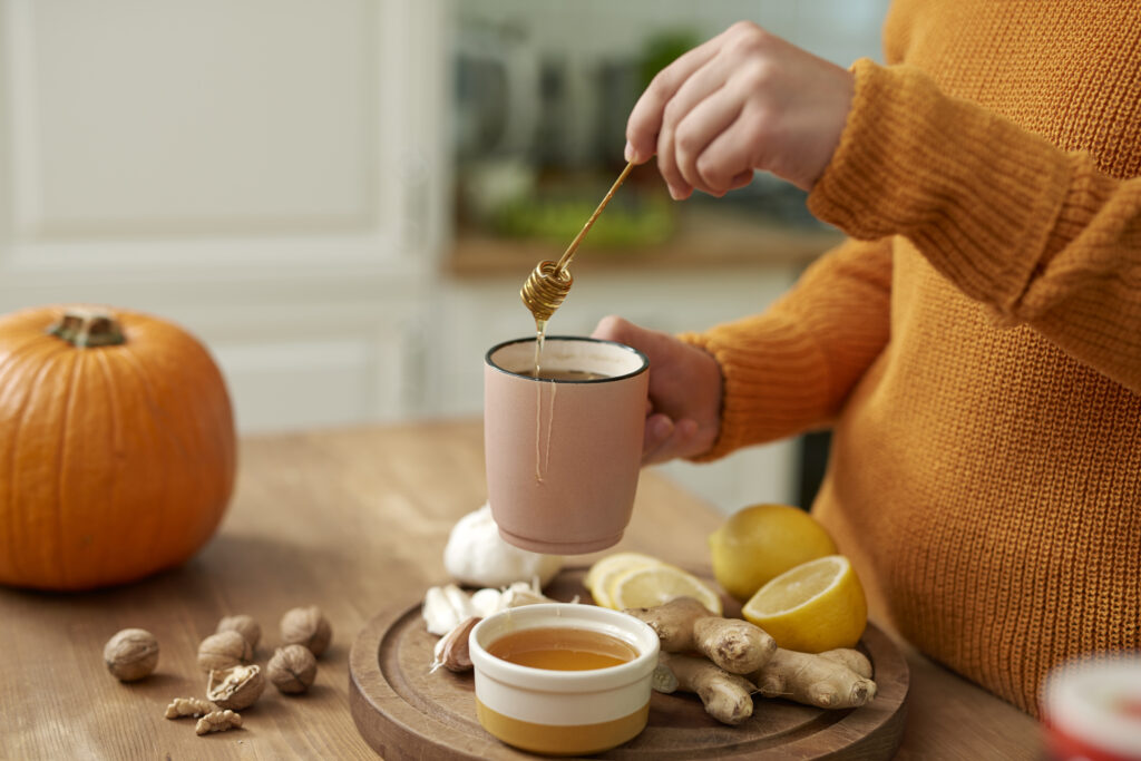 woman making hot tea with honey